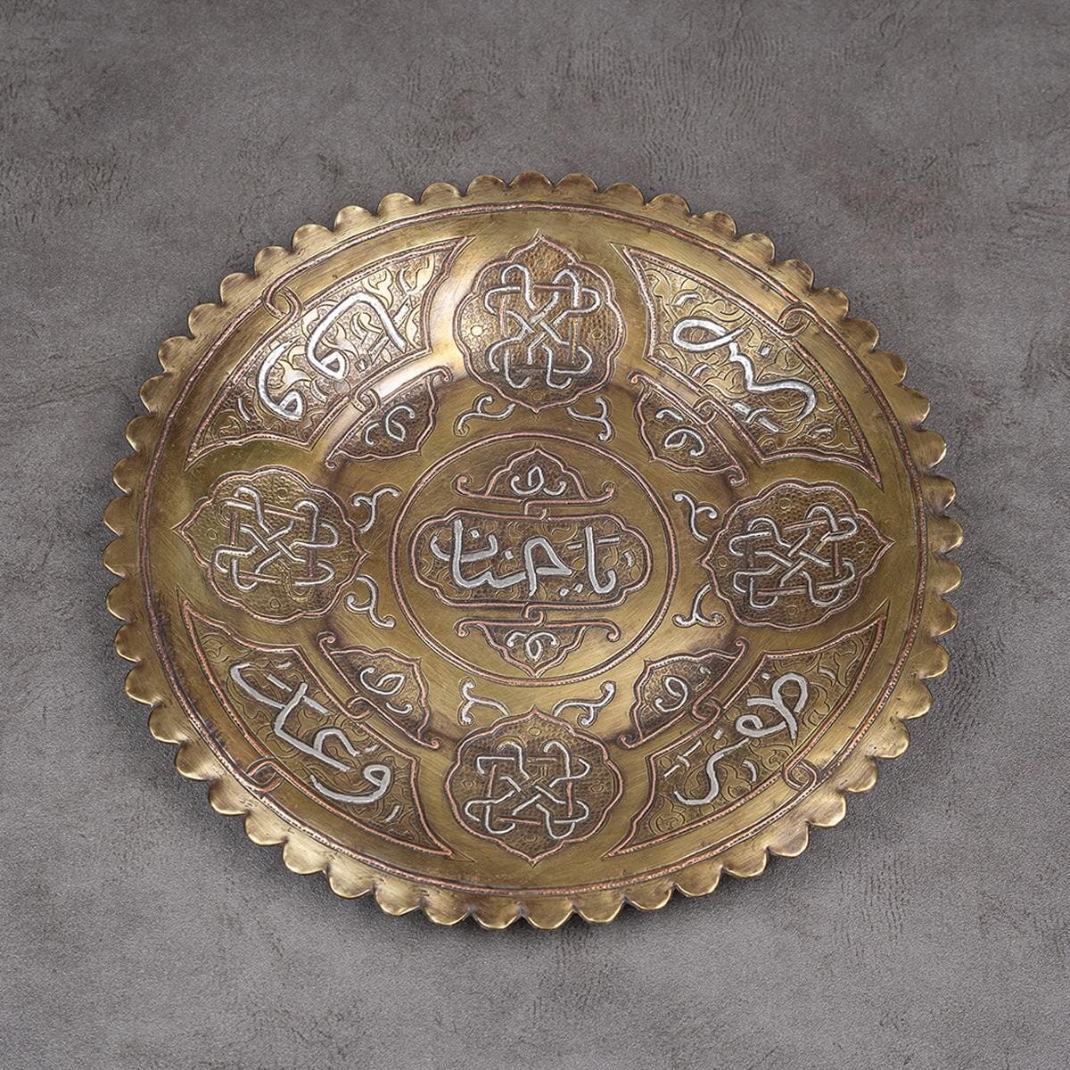 A plate made of brass inlaid with silver and red copper