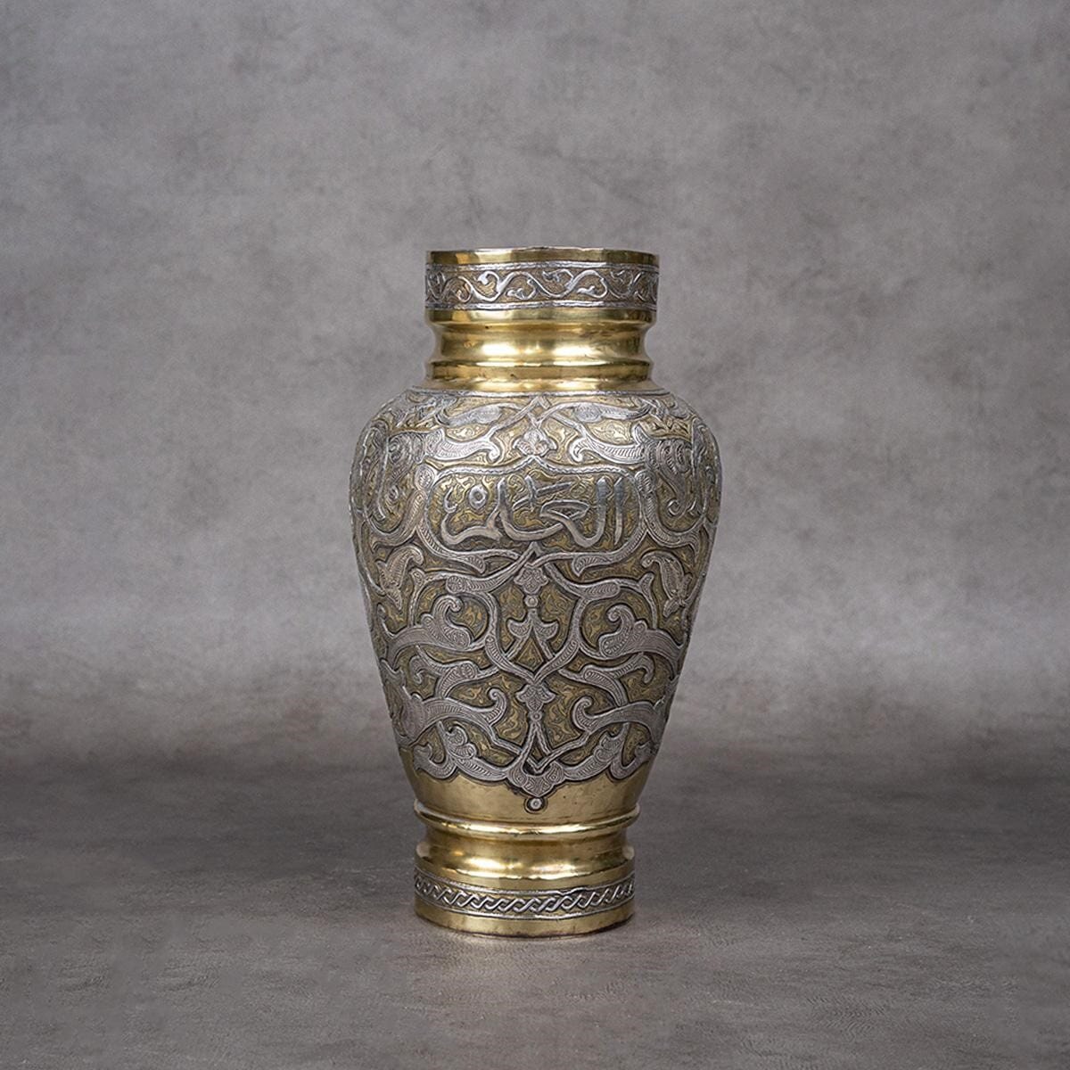 A vase made of brass and inlaid with silver