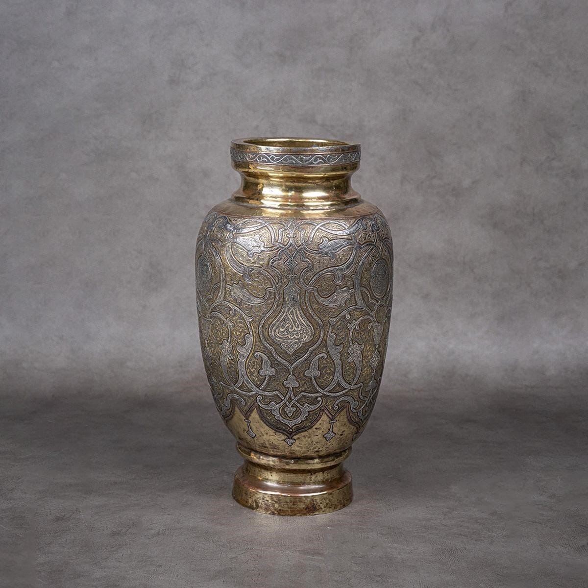 A vase made of brass and inlaid with silver